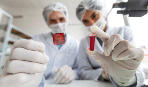 close-up-scientists-with-tube-glass-slide
